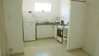 Cocina del Departamento LG en Las Grutas con heladera con freezer, horno, licuadora y pava eléctrica